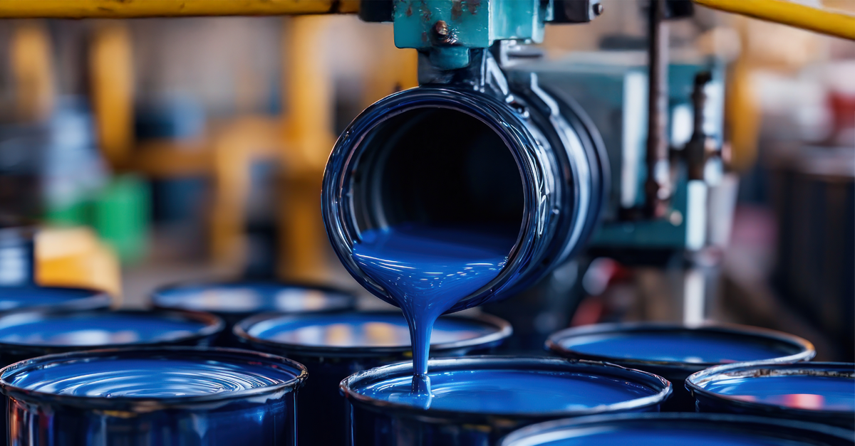 paint pouring into cans in a manufacturing facility